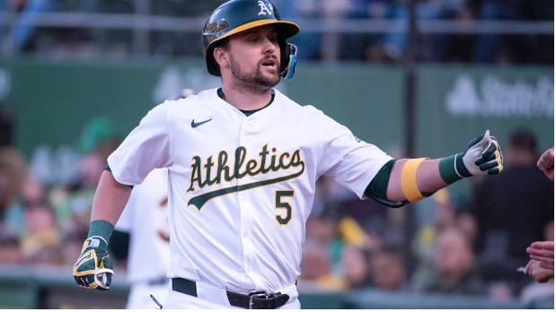 Oakland Athletics designated hitter J.D. Davis (5) celebrates with team mates after hitting a home run during the third inning against the Colorado Rockies