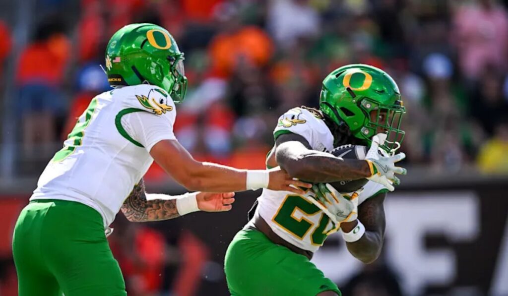 Oregon Ducks football team celebrating victory over Michigan State at Autzen Stadium