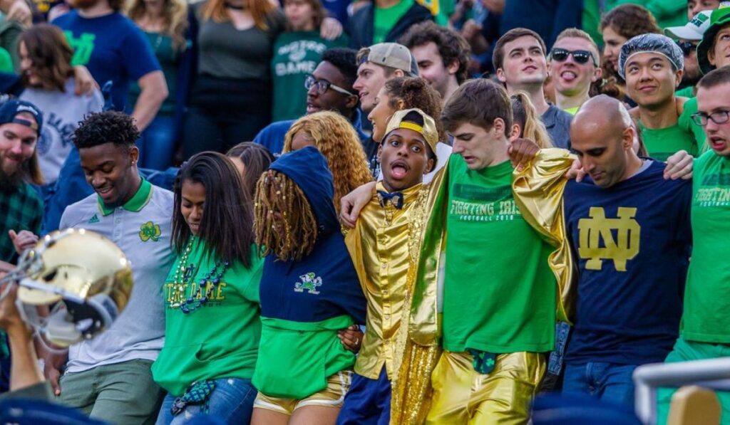 BREAKING NEWS: Top Notre Dame Recruit Continues to Impress' with a dynamic background of a football field and cheering fans, highlighting the excitement surrounding the recruit's performance.