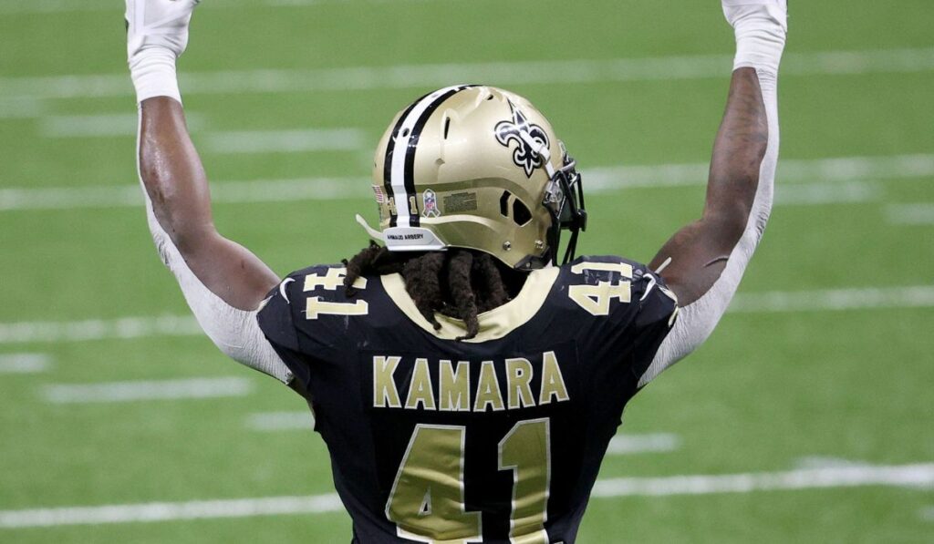 Alvin Kamara celebrating on the field with the New Orleans Saints, showcasing his passion for the team and the city of New Orleans.