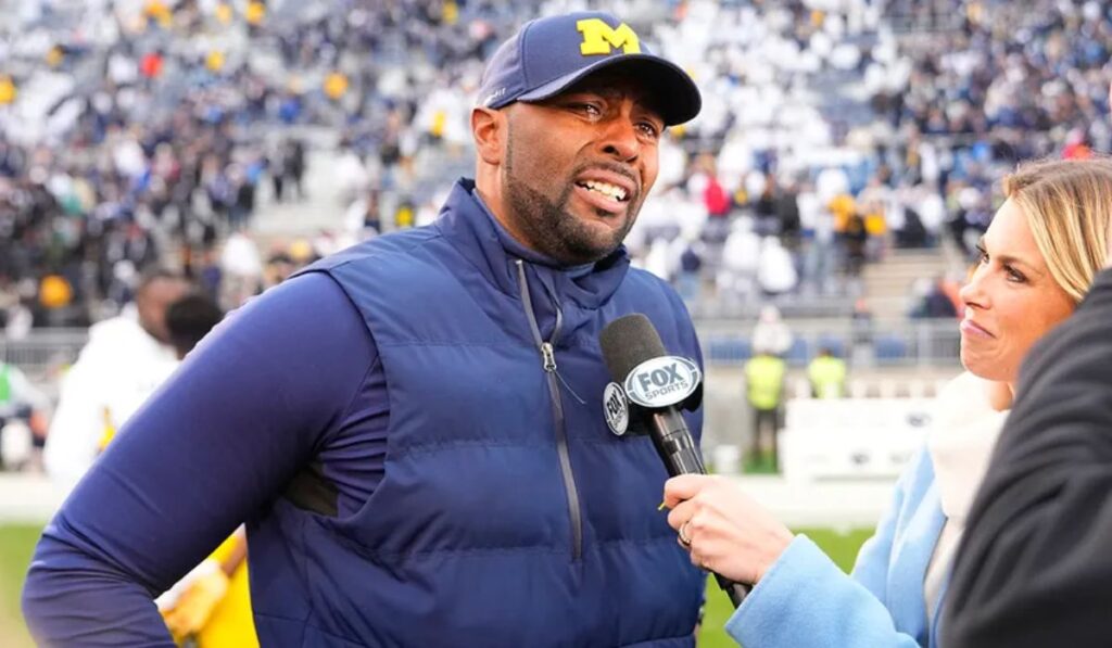 Michigan football players celebrate their victory over Michigan State, showcasing their teamwork and skill, as top recruiting prospects watch from the sidelines, impressed by the team's performance.