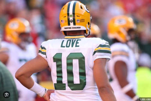 Jordan Love celebrating with Green Bay Packers teammates after scoring a touchdown"