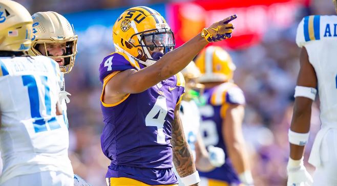 LSU Tigers' head coach Brian Kelly discussing injury updates on key wide receivers during a press conference.